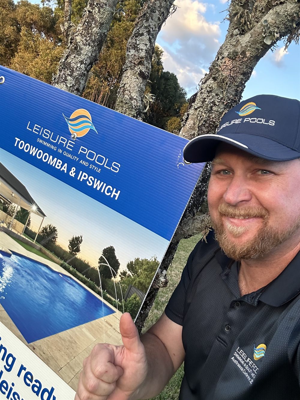 Luke from Pool Project Co with Leisure Pools Toowoomba and Ipswich signage